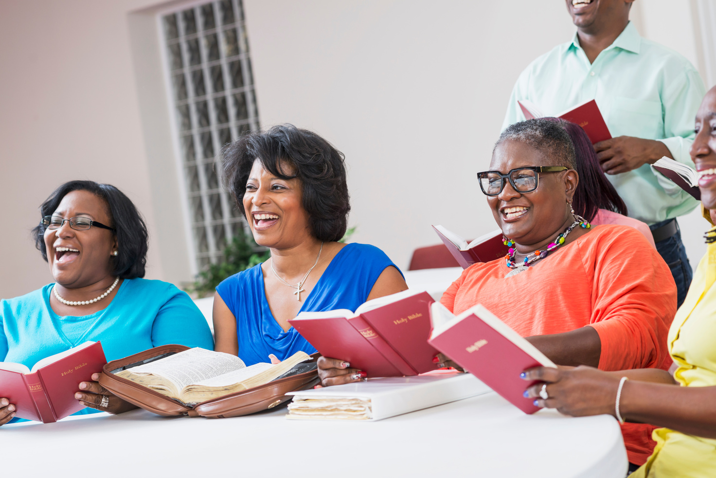 Group of mature black women in bible study meeting