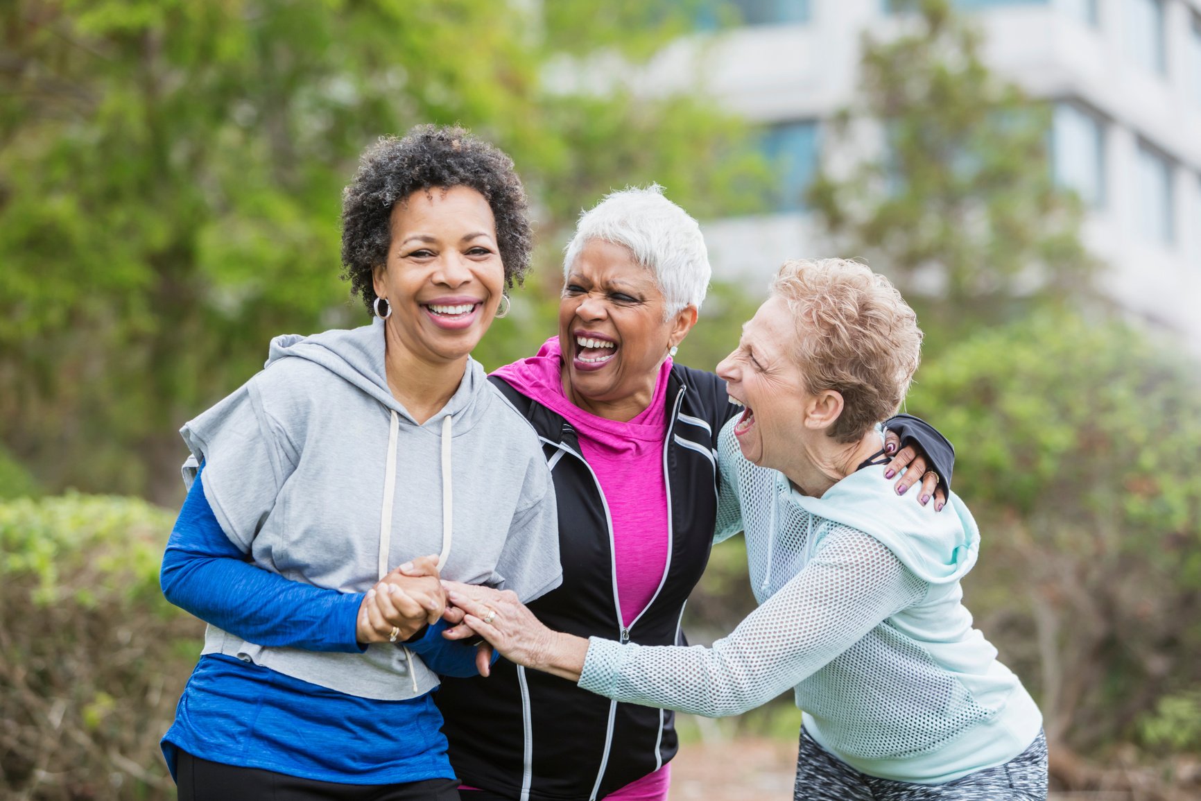 Three older multi-ethnic women hanging out together